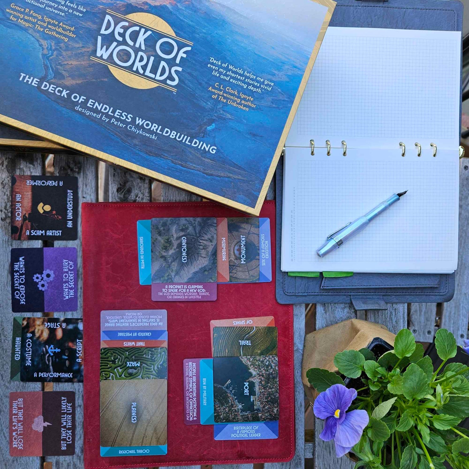 Deck of Worlds with a pen and notebook