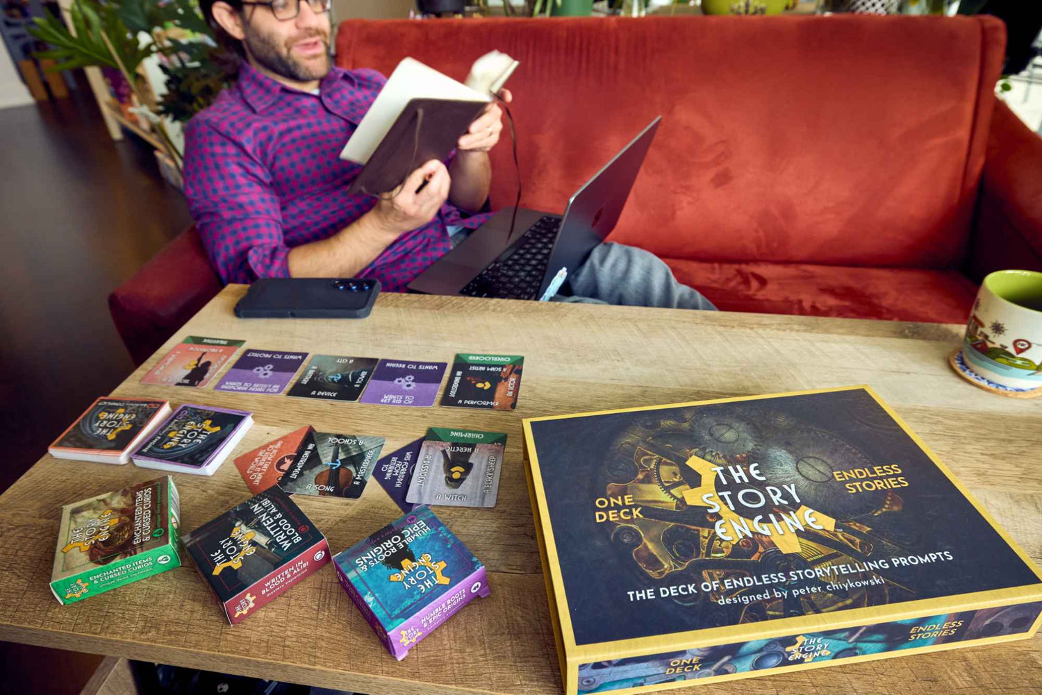 Writer using The Story Engine and curio expansions to write on his laptop