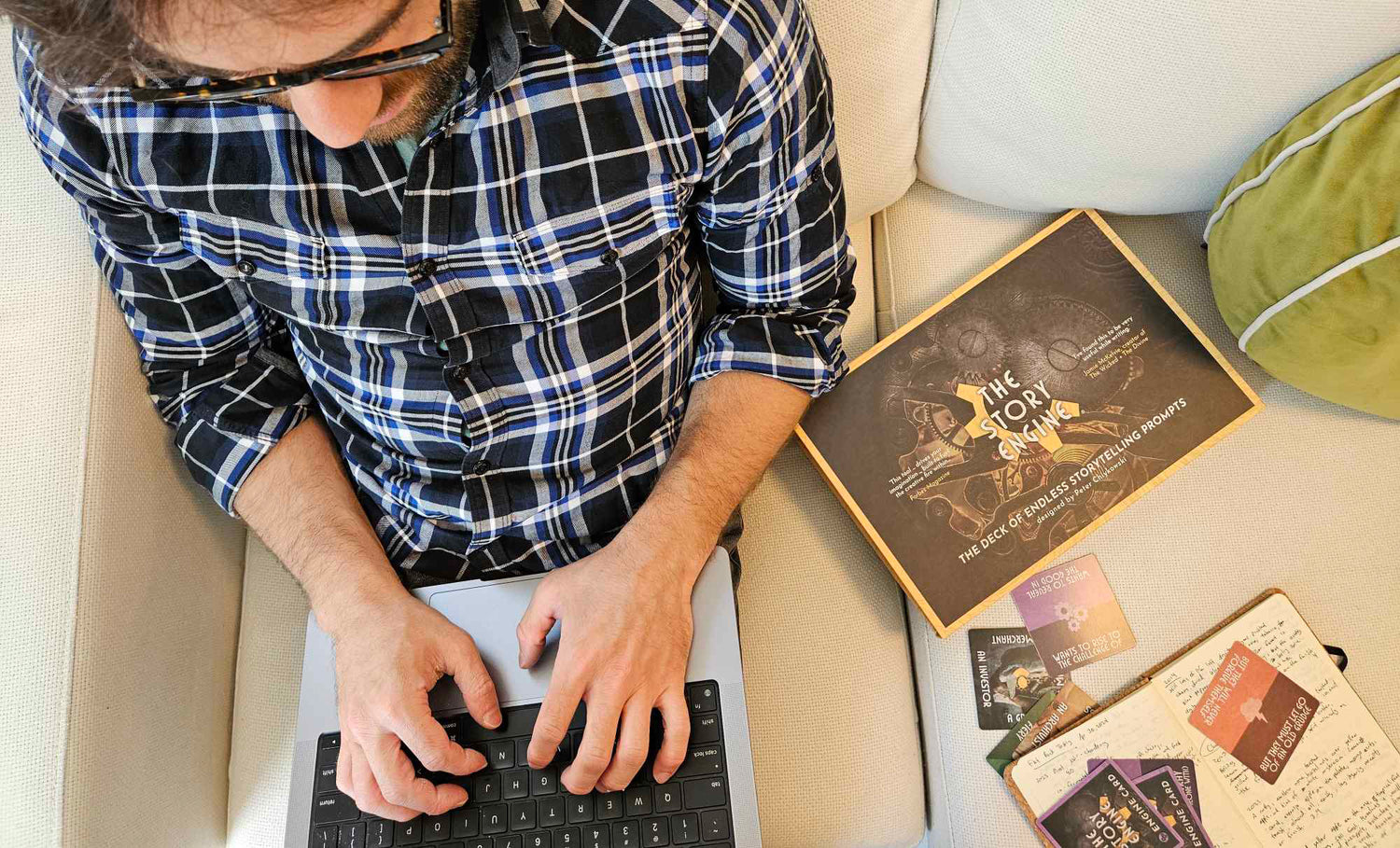 Writer using The Story Engine Deck n their laptop
